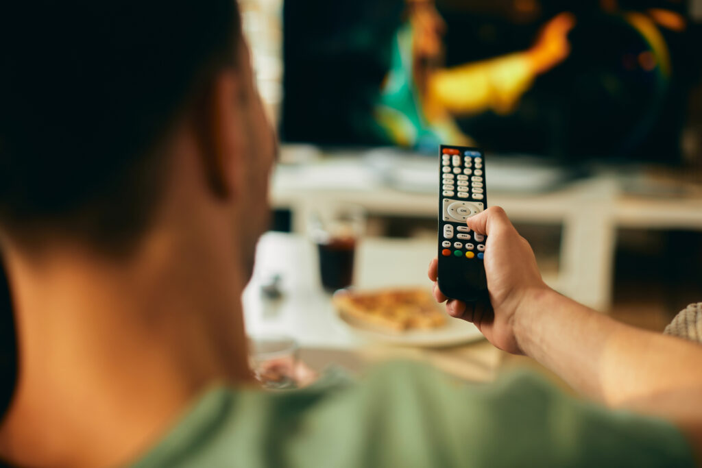 close up of man watching tv at home.